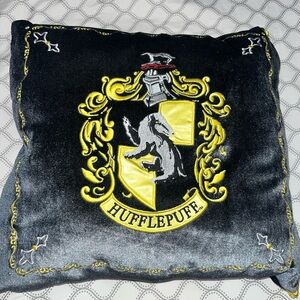 Hufflepuff decorative pillow with badger mascot. Official wizarding world merch